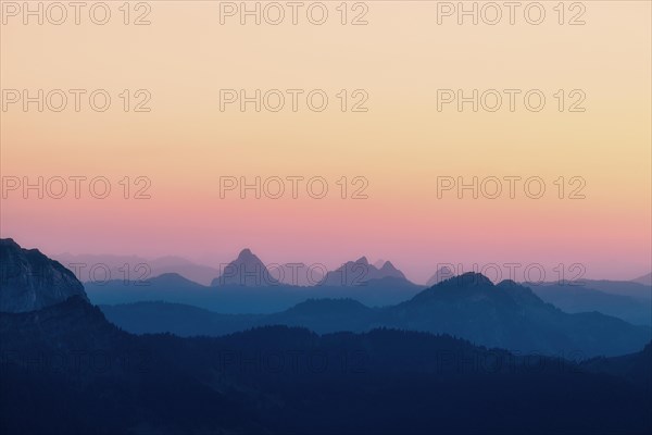 Hilly landscape with mountains Kleiner and Grosser Mythen after sunset