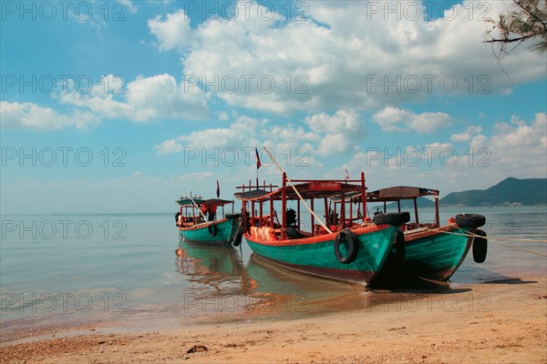 Khmer fishing boats moored at the shore of Koh Tonsay Island or Rabbit Island in Kep Cambodia