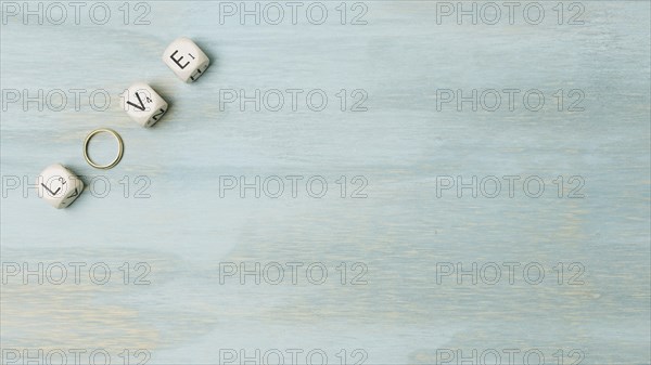 Overhead view text made with cubes wedding ring corner wooden backdrop