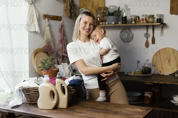 Medium shot woman holding baby