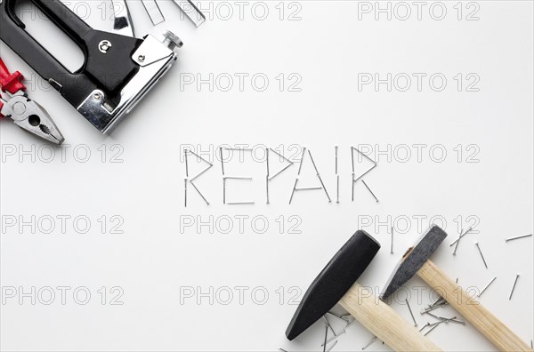 Hammers repair word written with nails
