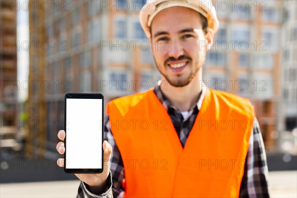 Medium shot portrait construction engineer holding phone