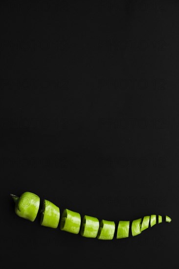 Chopped fresh green chili pepper black background