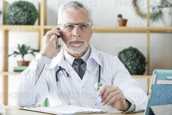 Doctor speaking phone looking away