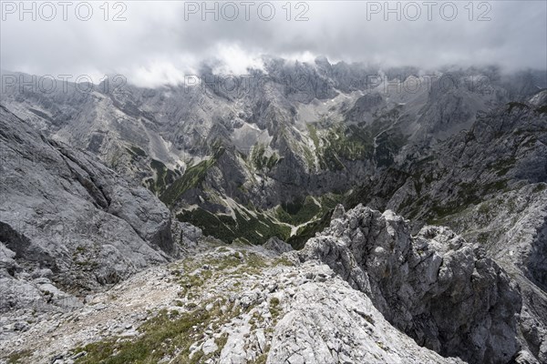 View from the summit of the Waxenstein over rocky and narrow ridge of the Waxenstein ridge to Hoellental with Jubilaeumsgrat