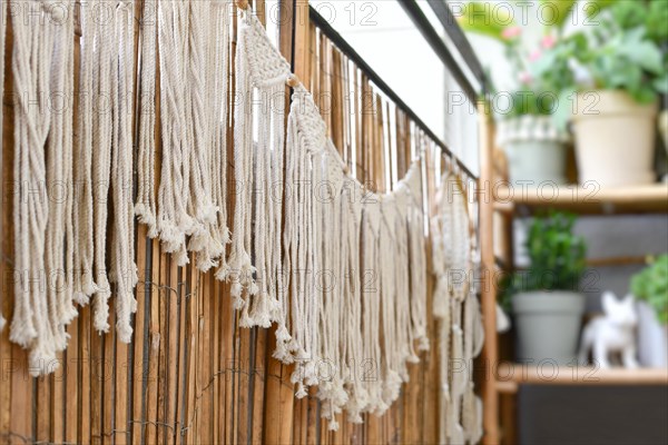 Makramee garland hanging on balcony reed screen