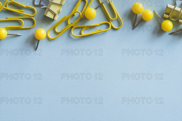 Yellow paper clips push pins binder clips