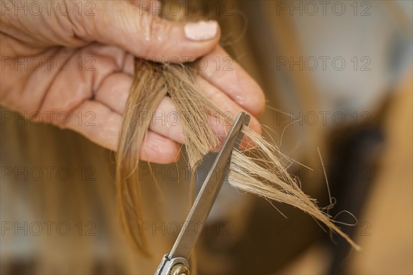 Woman getting her hair cut home by hairstylist