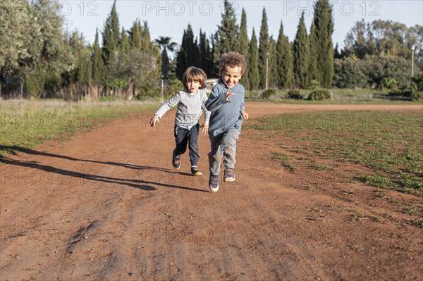 Little boys outdoors running