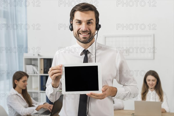 Man call center showing tablet