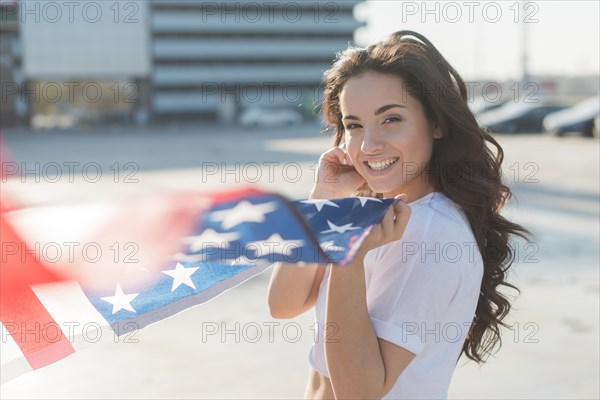 Beautiful woman holding big usa flag