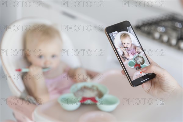 Close up mother taking picture baby