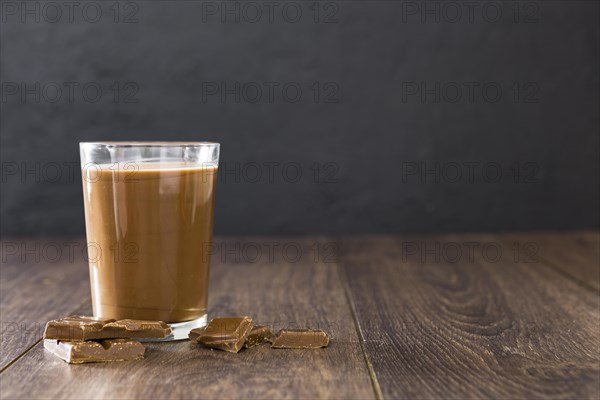 Transparent glass chocolate milkshake with copy space