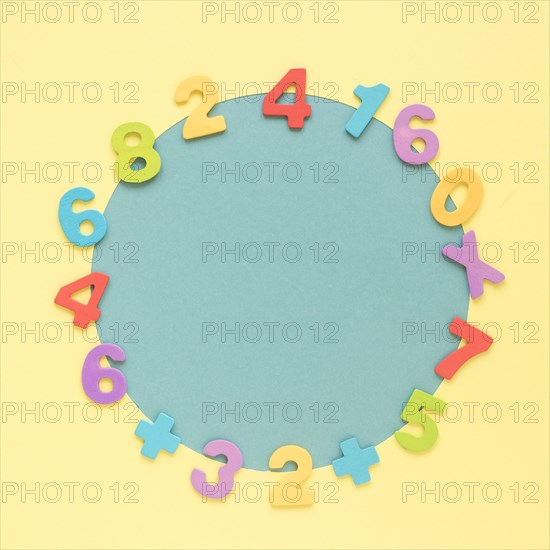 Colourful math numbers frame surrounding blue circular shape