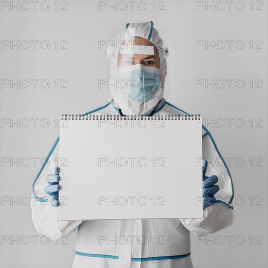 Front view doctor holding blank notebook