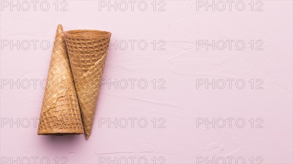 Empty waffle cones pink background