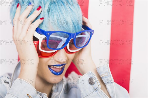 Usa independence day concept with punk woman with three sunglasses