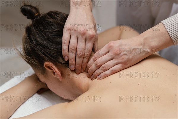 Close up therapist massaging neck