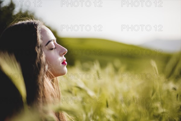 Woman sitting meditating grass