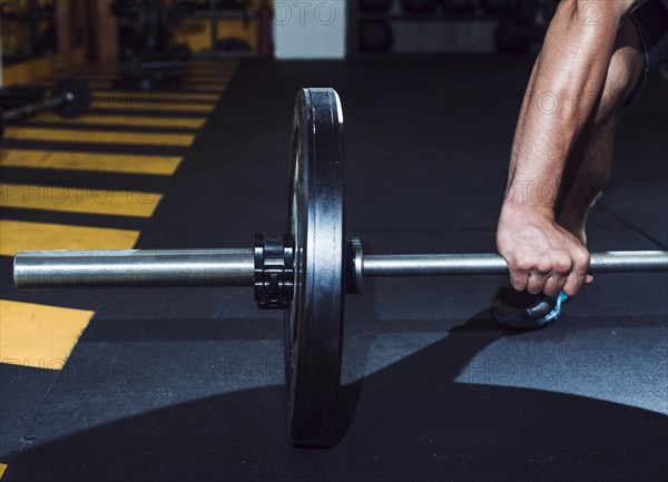 Close up man s hand lifting barbell