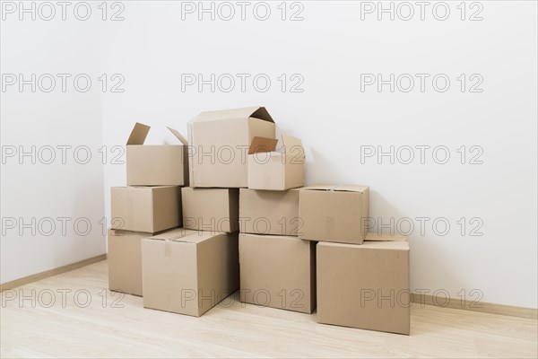 Moving cardboard boxes corner new room