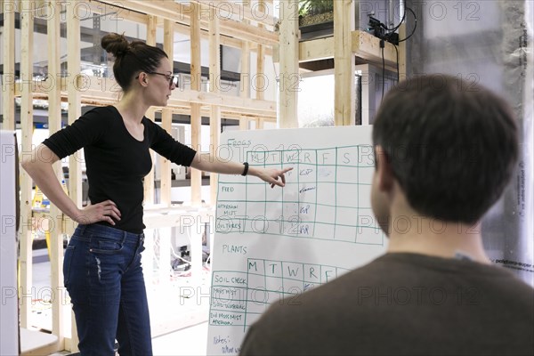 Woman showing schedule coworker