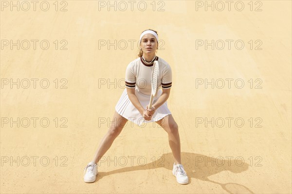 Young tennis player waiting ball