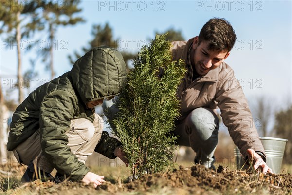 Father son planting tree