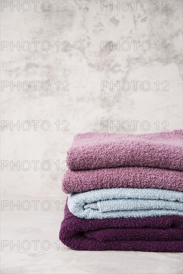 Front view stacked colourful towels