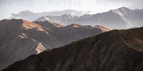 View over eroded mountainous landscape with brown hills