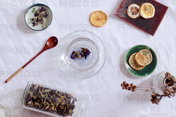 Overhead view of dried butterfly pea flowers or Clitoria ternatea and dried lemon slices for making herbal tea