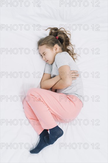 Elevated view sick girl wearing sock having pain stomach