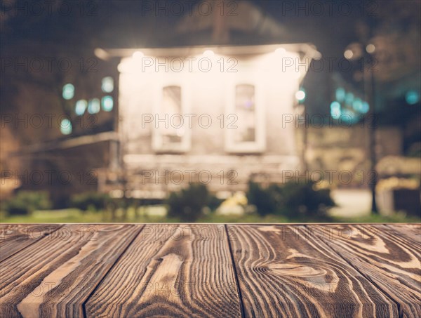 Wooden board empty table top on of blurred background. Perspective brown wood table over blur in coffee shop background