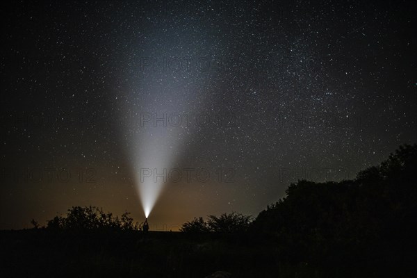 Man with flashlight enjoys beauty nature