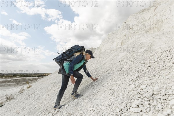 Full shot woman climbing up hill