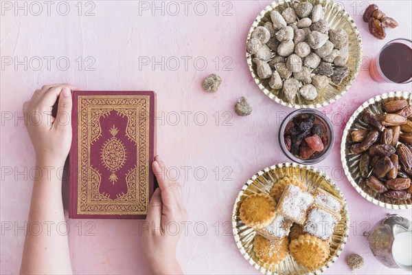 Hands with koran sweets