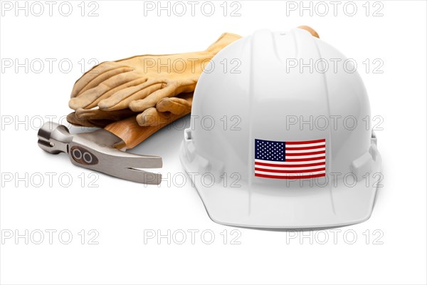 White hardhat with an american flag decal on the front with hammer and gloves isolated on white background