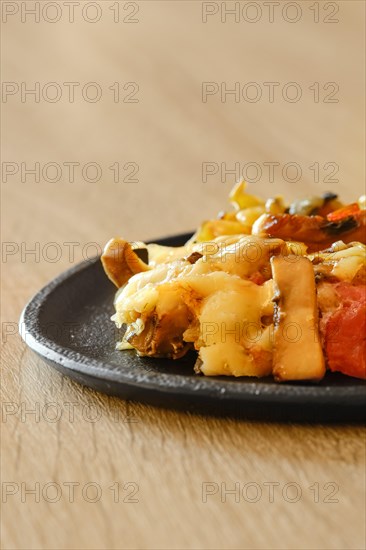 Closeup view of mushroom pasta with tomato and chanterelles on a plate