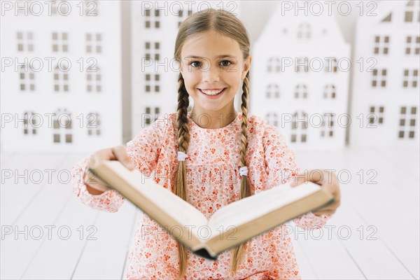 Lovely happy girl posing with book