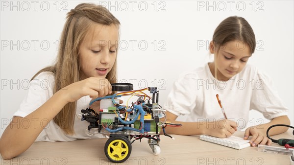 Two young girls doing science experiments together