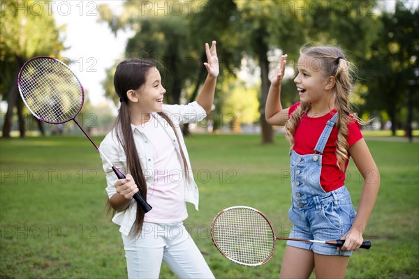 Little badminton players giving five