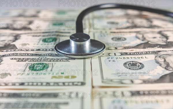 Stethoscope and money. Stethoscope on one dollar bills isolated with copy space