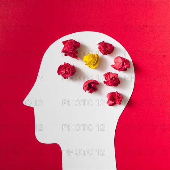 Crumpled paper cut out white human head red background
