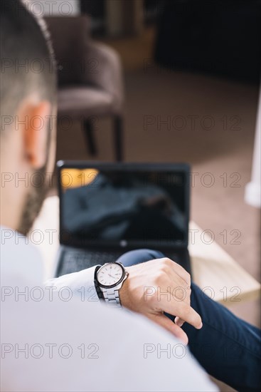 Businessman looking wristwatch