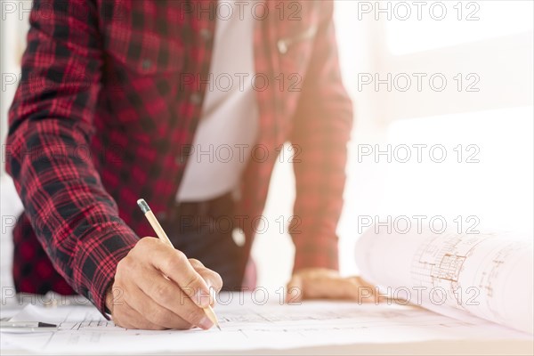 Medium shot man drawing architectural project