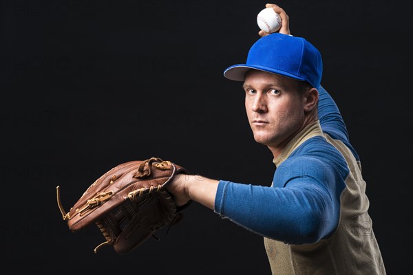 Baseball player with glove throwing ball