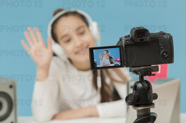 Close up camera tripod recording young girl