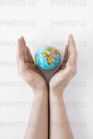 Person holding globe white background