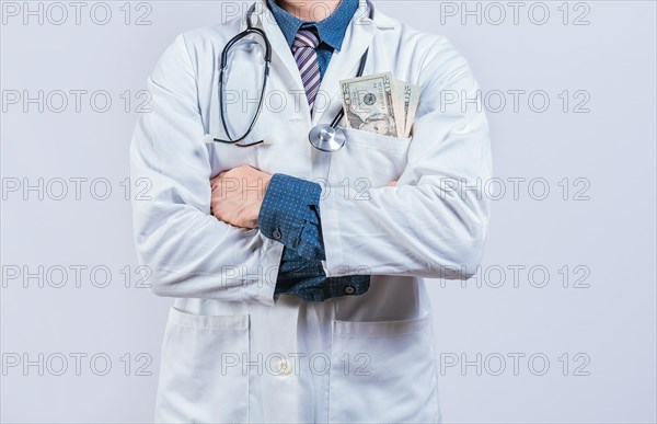 Corrupt doctor with bribe money in pocket isolated. Medical bribery concept. Bribed doctor with money in pocket isolated