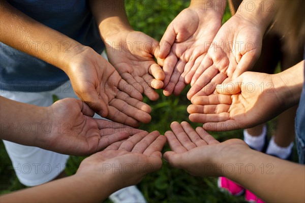 High angle friends showing hands camera